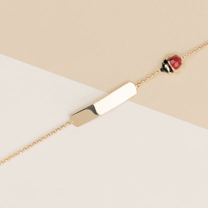 Bracciale baby coccinelle e targa oro giallo