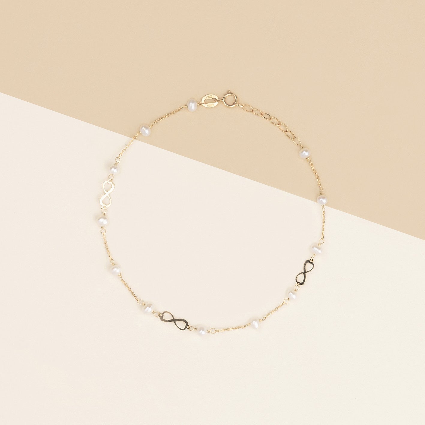 Bracciale baby con perline ed infinito oro giallo