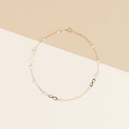 Bracciale baby con perline ed infinito oro giallo
