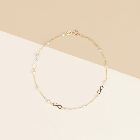 Bracciale baby con perline ed infinito oro giallo