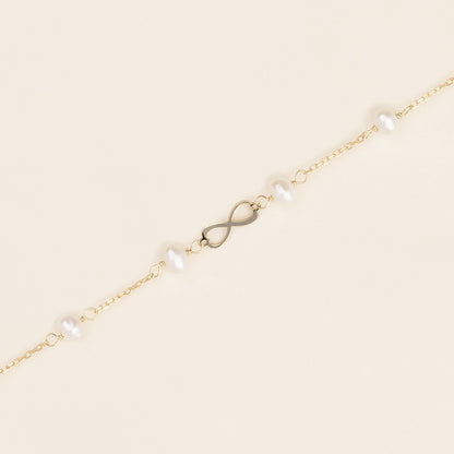 Bracciale baby con perline ed infinito oro giallo