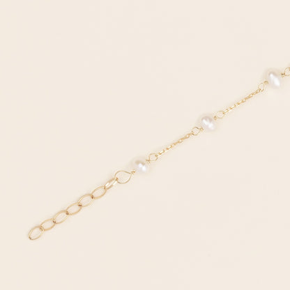 Bracciale baby con perline ed infinito oro giallo