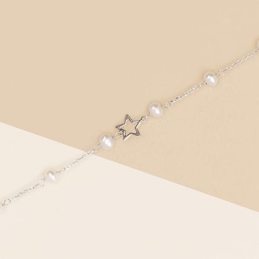 Bracciale baby con perline e stelle in oro bianco